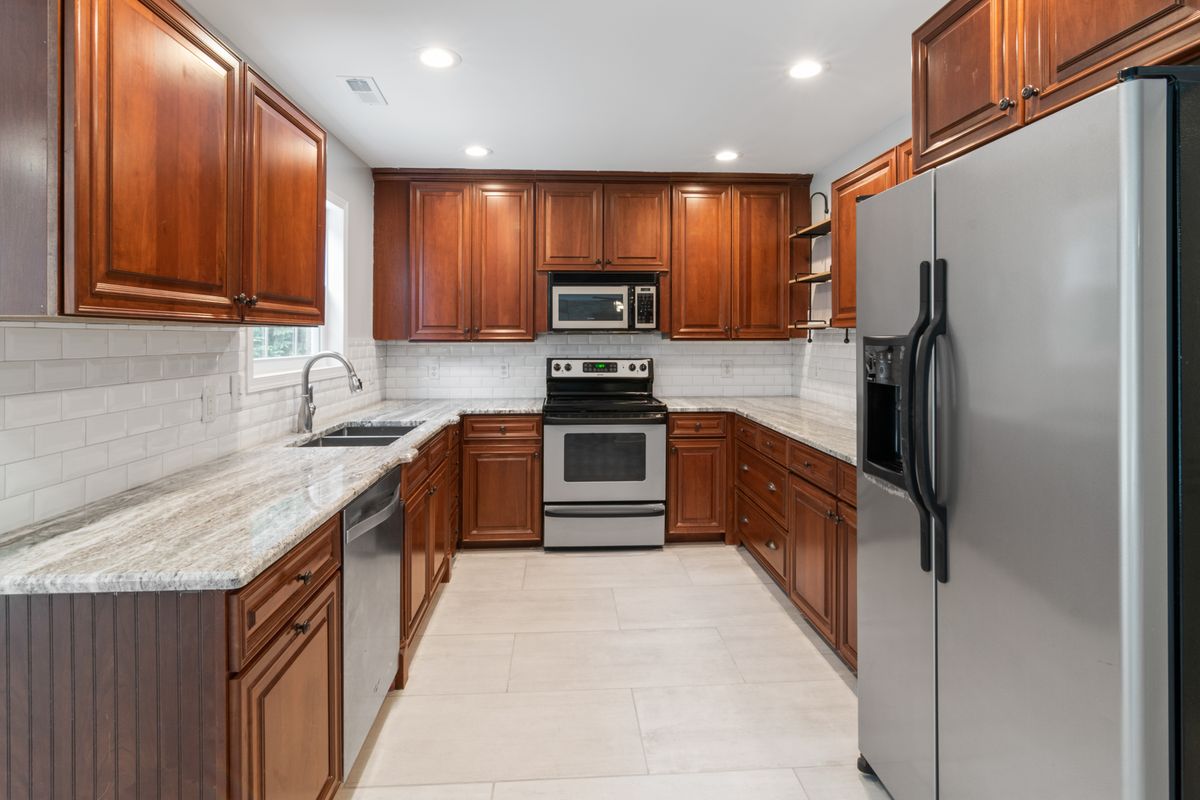 Kitchen remodel in progress with granite countertops and wood cabinetry by Art Lego LLC